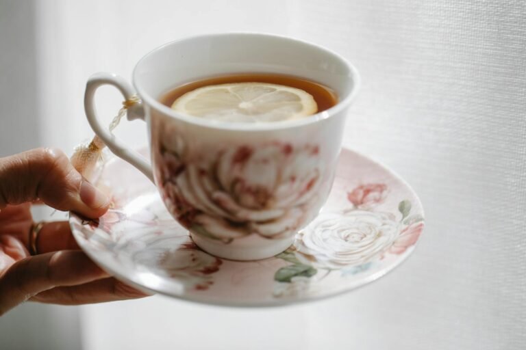 crop person with cup of tea